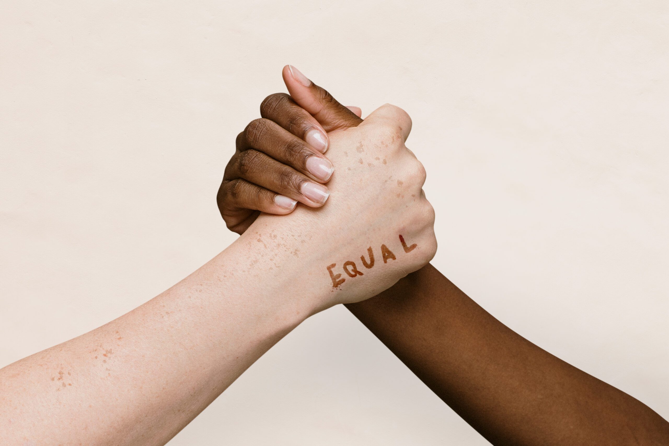 Equal word on two hands joining together background Equal word on two hands joining together background