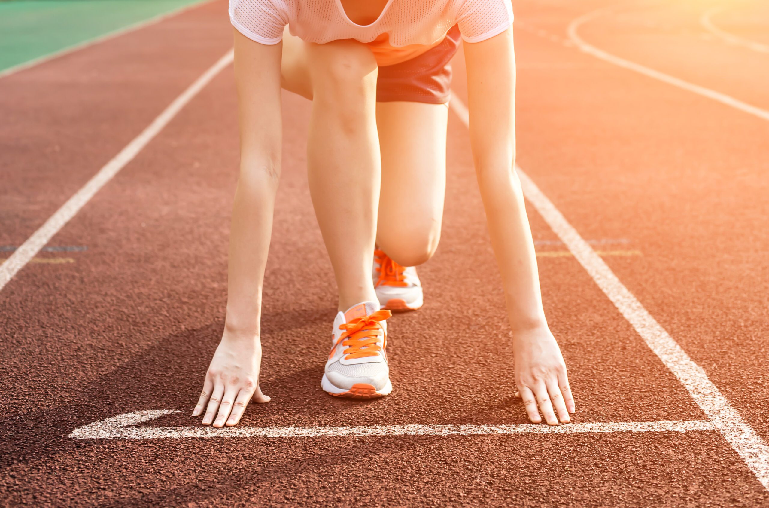 Athletic woman running on track Athletic woman running on track